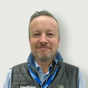 A member of staff, Barry Abbott in a blue shirt and a Lowdhams lanyard